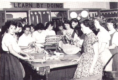 Girl's around a shop table