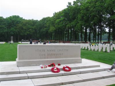 Memorial stone, with graves in the background