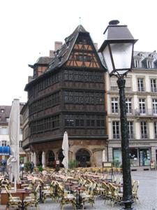 A square near the cathedral with tables and chairs set out for eating