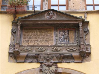 An inscription put up centuries ago by the owner.  Note the building date:  1574.