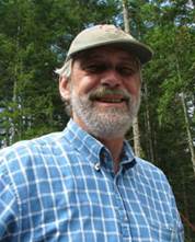 Photo of Bob in a blue checkered shirt, cap, and beard